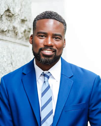 Headshot of Attorney Benoit smiling in a blue suit